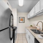 Winter Park Apartments - The Taylor - Kitchen with Spacious Countertops, White Cabinets, and Stainless-Steel Appliances