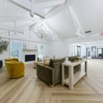 Clubhouse interior with lounge seating around next to an indoor fireplace and a view of a conference space