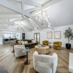 Clubhouse interior with lounge seating around next to an indoor fireplace