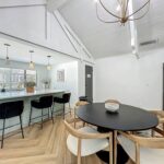 Clubhouse interior with island kitchen seating, microwave, and dining table and chairs