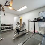 Two-BR Apartments in Winter Park, FL - The Taylor at Winter Park - Fitness Center Featuring Treadmill, Dumbbell Weights, and Bench