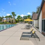 Lounge seating on a patio next to outdoor pool