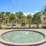 Outdoor hot tub in fenced in patio area